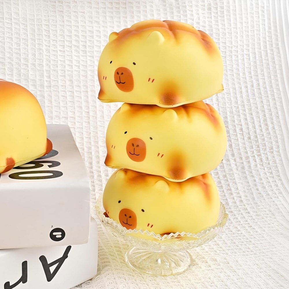 Soft capybara-shaped melon pan bread squishy toys with golden-brown baked textures and minimalist facial features