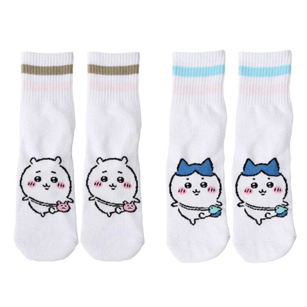 Featuring the pairs of officially licensed Chiikawa white crew-length socks, pink one holding a pink bear crossbody pouch and blue one holding a blue fish crossbody pouch.