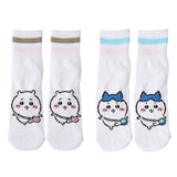 Featuring the pairs of officially licensed Chiikawa white crew-length socks, pink one holding a pink bear crossbody pouch and blue one holding a blue fish crossbody pouch.