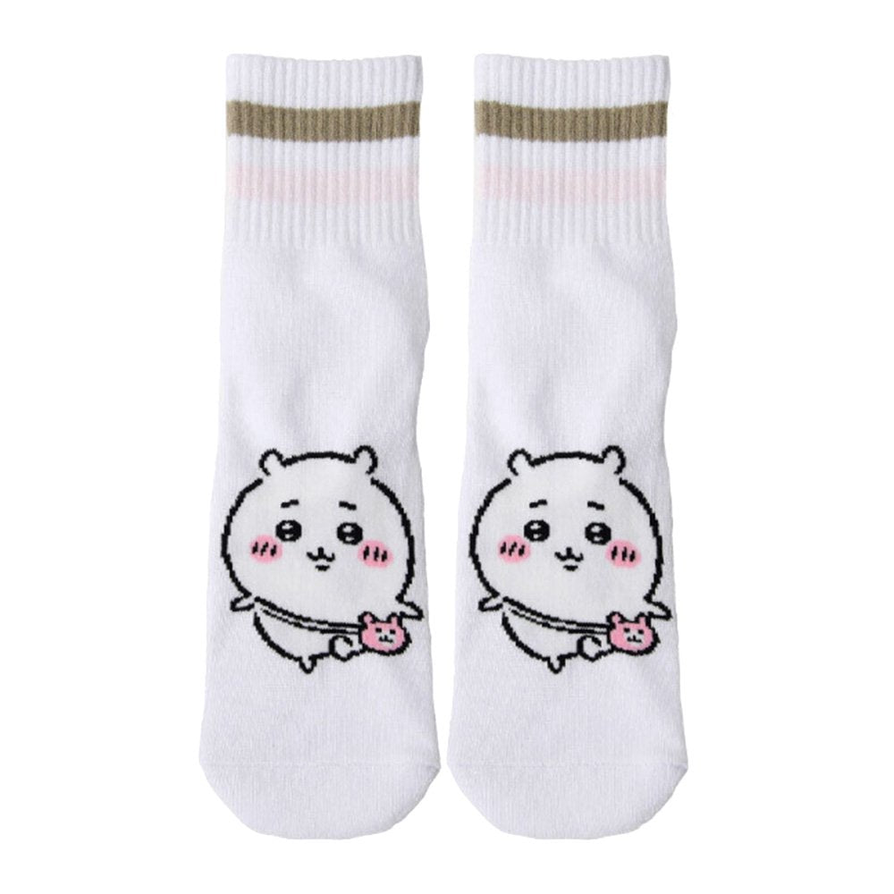 Featuring the pairs of officially licensed Chiikawa white crew-length socks, pink one holding a pink bear crossbody pouch and blue one holding a blue fish crossbody pouch.