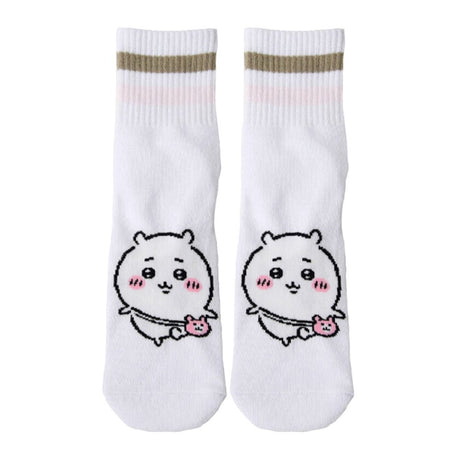Featuring the pairs of officially licensed Chiikawa white crew-length socks, pink one holding a pink bear crossbody pouch and blue one holding a blue fish crossbody pouch.