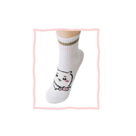 Featuring the pairs of officially licensed Chiikawa white crew-length socks, pink one holding a pink bear crossbody pouch and blue one holding a blue fish crossbody pouch.