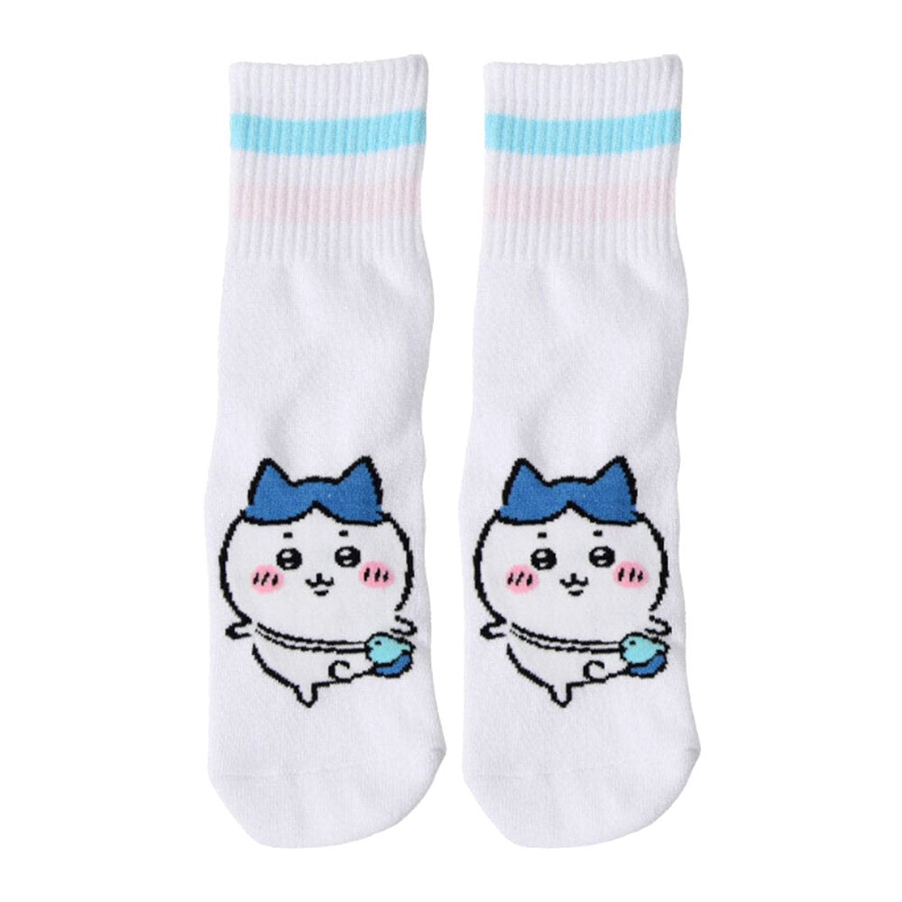 Featuring the pairs of officially licensed Chiikawa white crew-length socks, pink one holding a pink bear crossbody pouch and blue one holding a blue fish crossbody pouch.