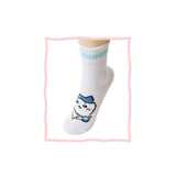 Featuring the pairs of officially licensed Chiikawa white crew-length socks, pink one holding a pink bear crossbody pouch and blue one holding a blue fish crossbody pouch.