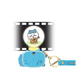 Functional Chiikawa Beam Projector Keychain showing Hachiware playing guitar image projected through the camera lens