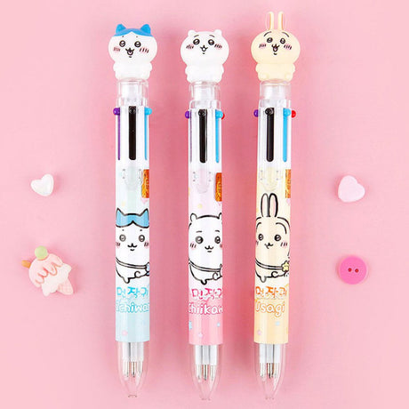 The officially licensed Chiikawa multi-color ballpoint pens in blue, pink, and yellow barrels. Each pen features a 3D character topper of Hachiware, Chiikawa, or Usagi and contains six different ink colors.