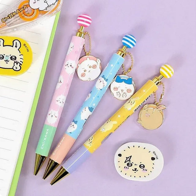 An official licensed collection of Chiikawa mechanical pencils in pink, blue, and yellow. Each pencil features a matching striped ball topper and a dangling enamel character charm of Chiikawa, Hachiware, or Usagi.