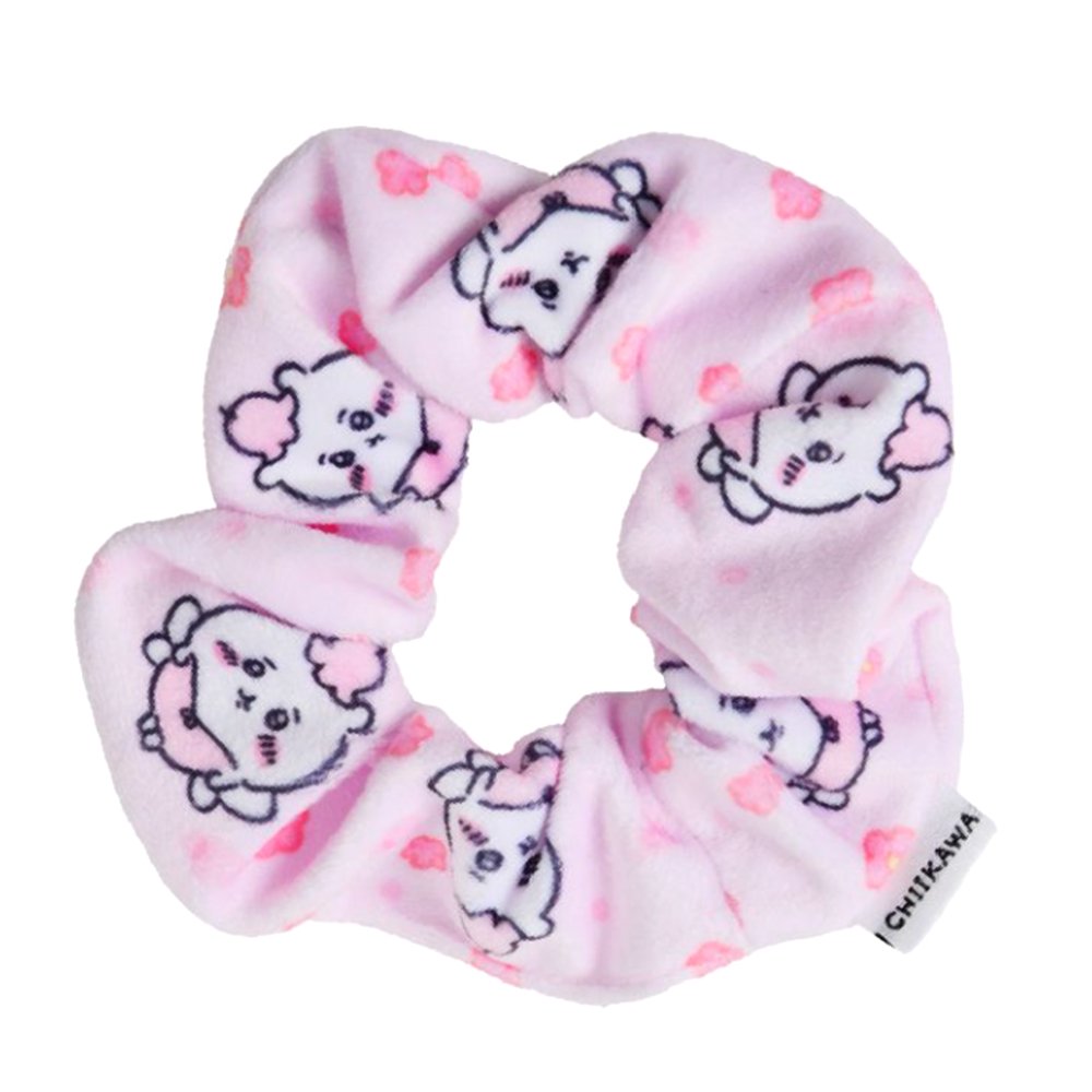 A pastel pink, plush fabric hair scrunchie featuring an all-over print of the officially licensed Chiikawa character with pink flower accents