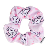 A pastel pink, plush fabric hair scrunchie featuring an all-over print of the officially licensed Chiikawa character with pink flower accents