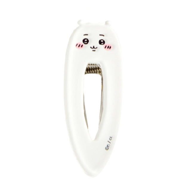 White teardrop-shaped Chiikawa character hair clip featuring a minimalist blushing face and a sturdy metal spring-loaded mechanism.