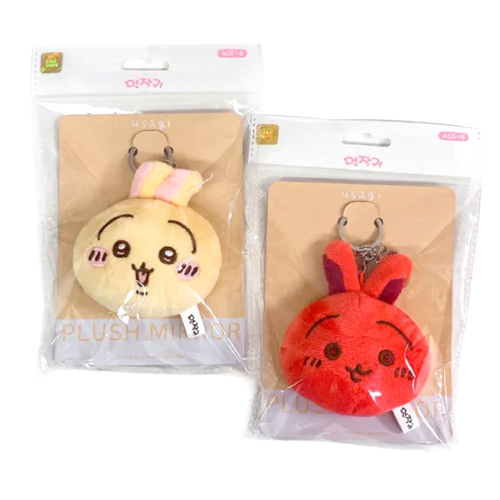 The officially licensed Usagi plush mirror keychains featuring two circular plush heads, one yellow and one red, show Usagi's embroidered face and long ears. The reverse side of the plush, revealing a built-in circular vanity mirror with a metal ring and a small character-themed acrylic charm.