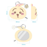 The officially licensed Usagi plush mirror keychains featuring two circular plush heads, one yellow and one red, show Usagi's embroidered face and long ears. The reverse side of the plush, revealing a built-in circular vanity mirror with a metal ring and a small character-themed acrylic charm.