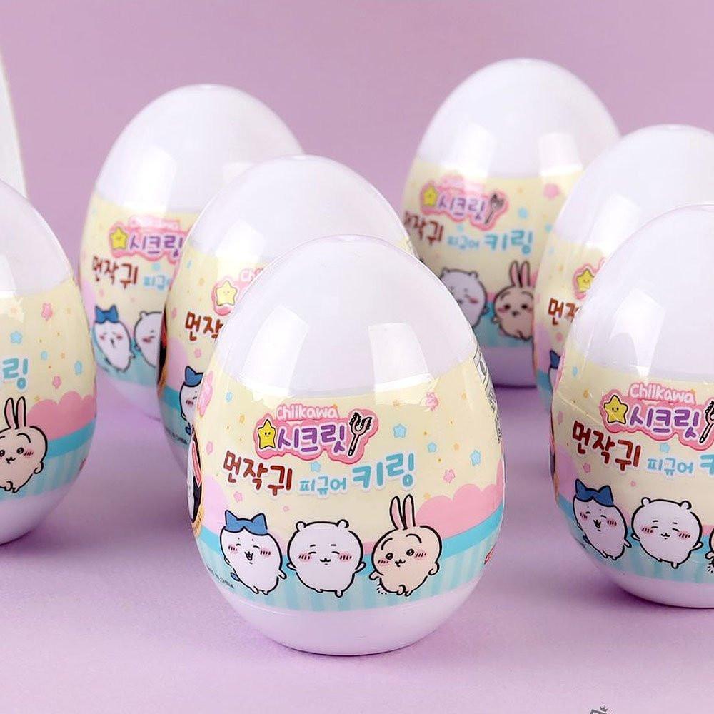 Pastel-colored toy eggs with Chiikawa, Hachiware, and Usagi characters on a pink background