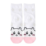 Featuring the pairs of officially licensed Chiikawa white crew-length socks, pink one surrounded by small pink-and-white flowers and blue one surrounded by blue-and-yellow flowers.