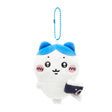 An officially licensed Hachiware plush keychain holding a small camera, suspended from a blue ball chain