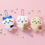 An officially licensed set of Chiikawa plush keychains featuring Chiikawa, Hachiware, and Usagi holding miniature accessories, displayed with color-matched ball chains