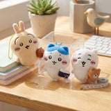 An officially licensed set of Chiikawa plush keychains featuring Chiikawa, Hachiware, and Usagi holding miniature accessories, displayed with color-matched ball chains