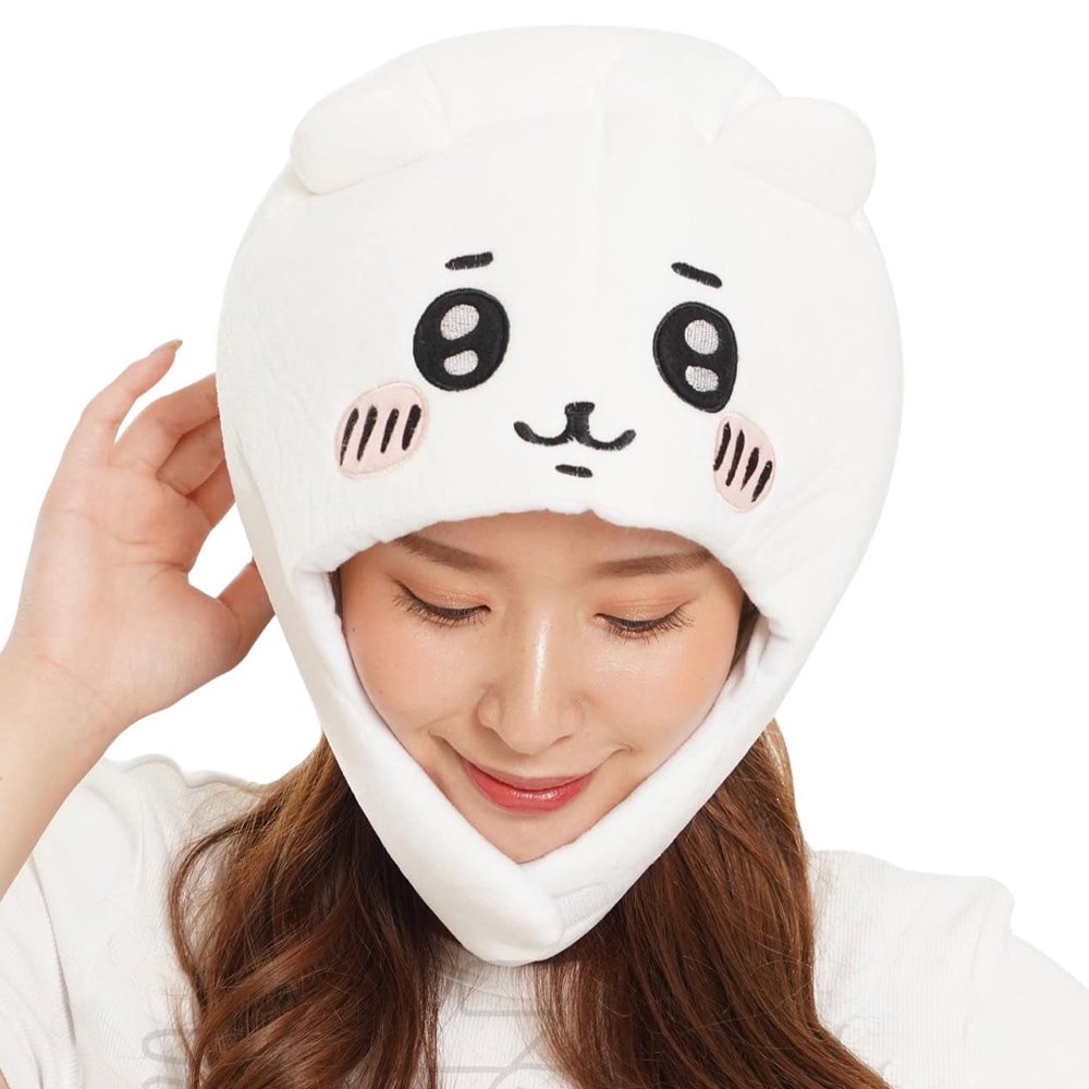 An officially licensed white Chiikawa plush character hat with embroidered eyes, blushing cheeks, and long ear flaps.