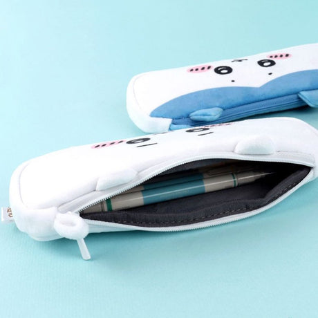 Three officially licensed plush Chiikawa character pencil cases featuring: the yellow-colored with Usagi's face and long ears; the white with Chiikawa's face; the white and blue with Hachiware's face and blue ears. Each pouch features embroidered eyes, pink cheeks, and a top zipper.