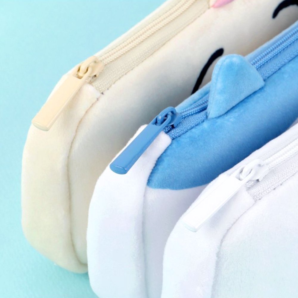 Three officially licensed plush Chiikawa character pencil cases featuring: the yellow-colored with Usagi's face and long ears; the white with Chiikawa's face; the white and blue with Hachiware's face and blue ears. Each pouch features embroidered eyes, pink cheeks, and a top zipper.