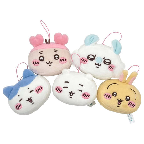 A group of five officially licensed Chiikawa plush face charms, including characters like Chiikawa, Hachiware, and Usagi, shown with colorful ears and pink blushing cheeks. Each round, soft mascot features a pink hanging loop.