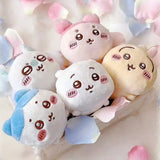 An collection of five officially licensed Chiikawa "nesoberi" laying-down plush toys, featuring the characters Chiikawa, Hachiware, Usagi, Momonga, and Kani against a green polka-dot background. The plushies are small, rounded, and white, blue, yellow, and pink in color with sweet embroidered faces.