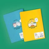 Officially licensed Chiikawa "Adventure Record Notebooks" featuring colorful comic book panel covers. The open notebook reveals interior pages with structured writing boxes decorated with teal character illustrations and header icons.