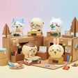 A collection of officially licensed Chiikawa digital watches featuring characters like Chiikawa, Hachiware, and Usagi sitting behind miniature cardboard box bases. Each base includes a small digital clock screen, and the set includes five visible designs.