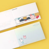Officially licensed Chiikawa memo pads, one featuring a blue aquatic theme and the other a colorful comic book panel design. The interior pages show detailed character illustrations of Chiikawa, Hachiware, and Usagi.
