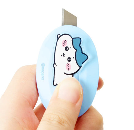 Three officially licensed Chiikawa mini retractable utility knives in yellow, light blue, and pink. Each oval-shaped cutter features a 3D-style character (Usagi, Hachiware, or Chiikawa) in a laying down pose.