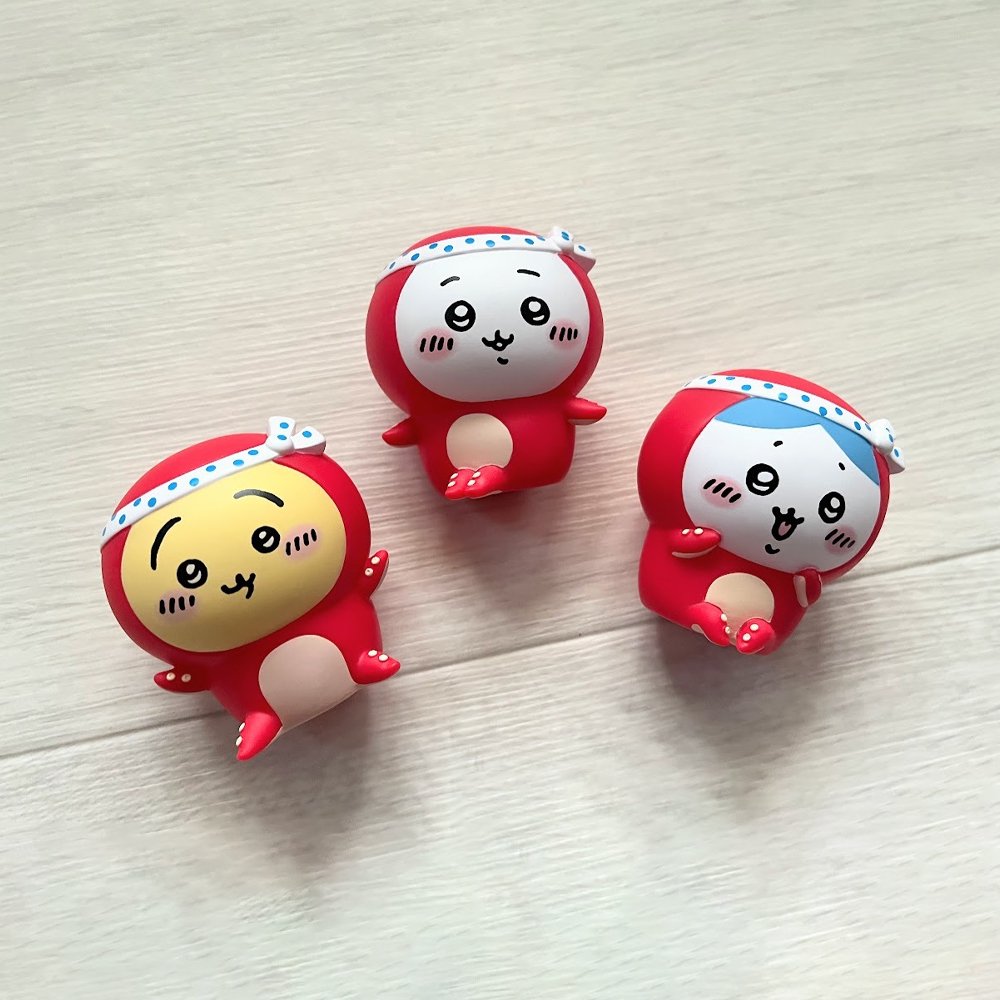 Four officially licensed Chiikawa vinyl figures, featuring characters Chiikawa, Usagi, and Hachiware in red octopus and white squid costumes with blue and white polka-dot headbands.