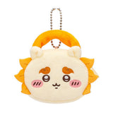 An officially licensed Chiikawa and Friends fluffy mini pouch keychain, featuring the ivory yellow, round pouch features Shisa's face with embroidered details like orange mane and plush ears, and a silver ball chain for hanging.