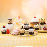 An official licensed collection of Chiikawa mystery Sweet Series blind boxes featuring brown and secret pink cupcake-themed packaging. Characters like Chiikawa, Hachiware, and Usagi are styled as cupcakes with frosting and sprinkles.