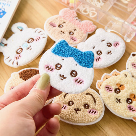 Officially licensed Chiikawa collection of eight fuzzy, plush-embroidered ticochi character face magnet blind box featuring Chiikawa, Hachiware, Usagi, and friends

