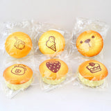 Custard Bun Squishy toys styled like golden baked custard bread with printed bear and dessert illustrations