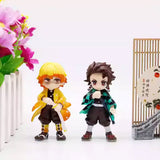 A collection of six officially licensed Demon Slayer figures, featuring Tanjiro, Nezuko, Zenitsu, Inosuke, Giyu, and Rui in their signature outfits.