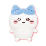 Front view of the officially licensed Hachiware sitting plush toy from the Chiikawa Vol. 1 blind box series. A white plush character featuring distinctive blue ears, a blue pattern on its head, rosy cheeks, and a happy expression sitting on a white background.