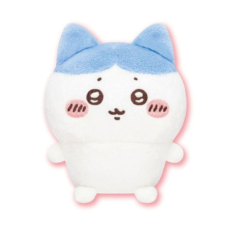 Front view of the officially licensed Hachiware sitting plush toy from the Chiikawa Vol. 1 blind box series. A white plush character featuring distinctive blue ears, a blue pattern on its head, rosy cheeks, and a happy expression sitting on a white background.