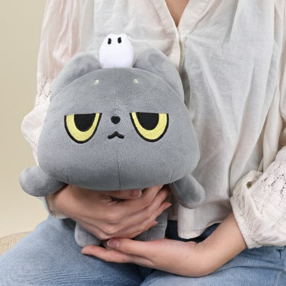 Person holding a grey cat Hakongee plush toy with a ghost on its head