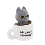 Black cat plush toy inside a mug with 'No Coffee No Worries' text on a white background