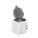 Black cat plush cat toy with yellow eyes sitting inside a white mug on a white background