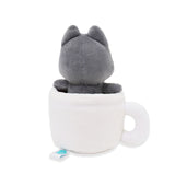 Black cat Hakongee toy inside a white mug on a white background