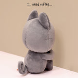  Black Cat plush toy with text 'I... need coffee...' on a beige background