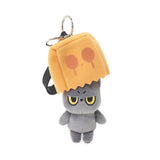 A grumpy Hakongee grey cat plush keychain wearing a brown paper bag over its head, officially licensed and made by WSL