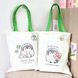 Koupen Chan Tote Bags : Official licensed Koupen Chan canvas tote bags with green handles. One features the penguin with clovers, the other with a flower bouquet.
