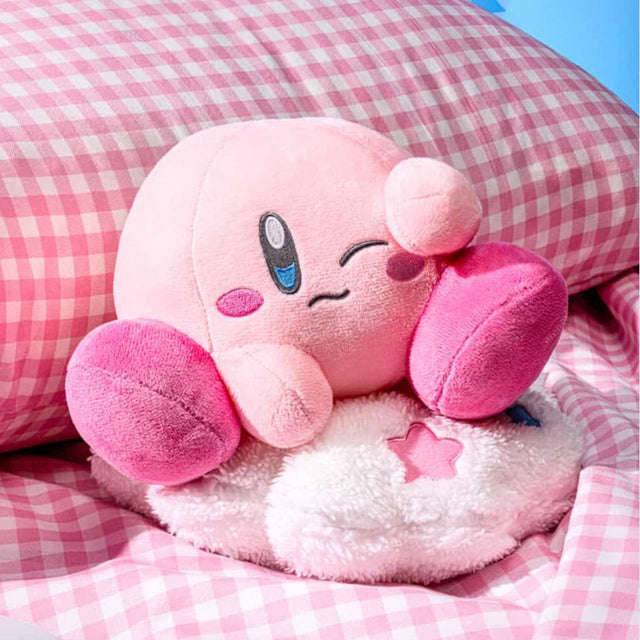 An officially licensed Kirby plush pillow featuring Kirby dozing off, winking, and resting on a fluffy white cloud plush