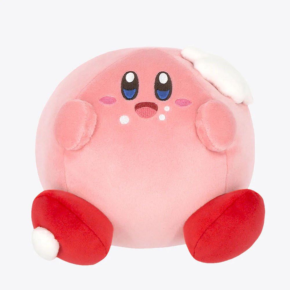 A plush toy depicting the character Kirby from the Nintendo series, showing a pink round body with facial features and red boots.