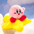An officially licensed Kirby's Dream Land plush toy featuring a pink Kirby sitting on top of a fluffy yellow star plush