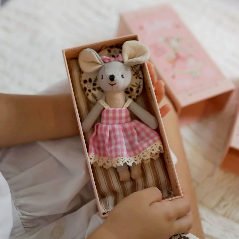 Levlovs' stuffed Mouse Lulu plush doll with large round ears wearing a pink gingham dress rests inside a decorated pink gift box alongside matching patterned bedding