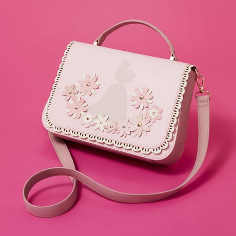 Light pink crossbody bag by the collaboration of Loungefly and Disney featuring silhouettes of Disney Princess, decorated with 3D faux leather flowers with gold studs and a scalloped lace-style border.